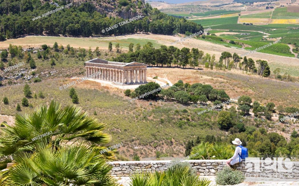 Stock Photo: Visitor admiring view over the magnificent Doric temple at the ancient Greek city of Segesta, Calatafimi, Trapani, Sicily, Italy, Mediterranean, Europe.