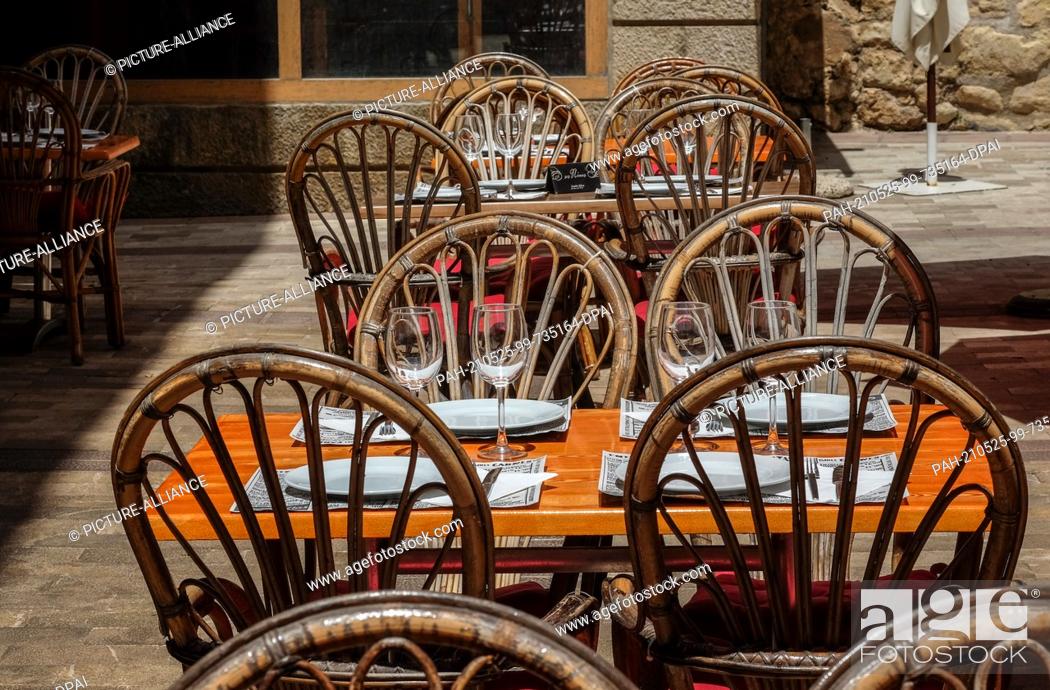 Stock Photo: 24 May 2021, Spain, Manacor: Empty are set tables in a restaurant in Manacor in the east of the island of Mallorca. Not many tourists have arrived on the island.