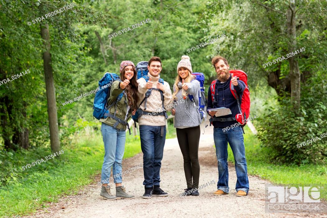 Stock Photo: friends hiking with backpacks and show thumbs up.