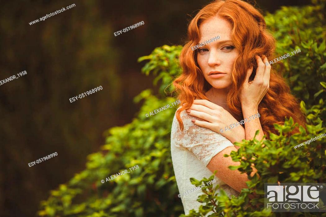 Beautiful redhead woman with long curly hair and green - grey eyes,  freckles, Stock Photo, Picture And Low Budget Royalty Free Image. Pic.  ESY-051968990 | agefotostock