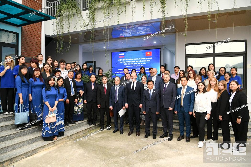 Stock Photo: VIETNAM, HANOI - APRIL 7, 2023: Russian Deputy Prime Minister Dmitry Chernyshenko (C) poses for a group photo during a visit to the Vietnam National University.