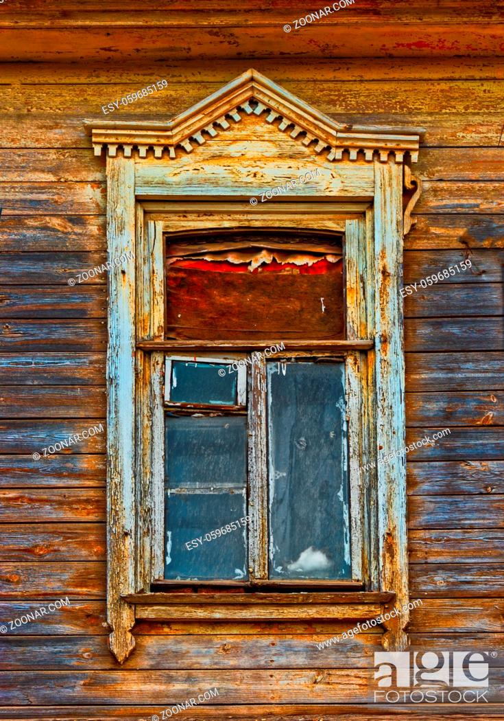 Imagen: Wooden window of ild house with carved frame of wooden lacy in Astrakhan Russia.