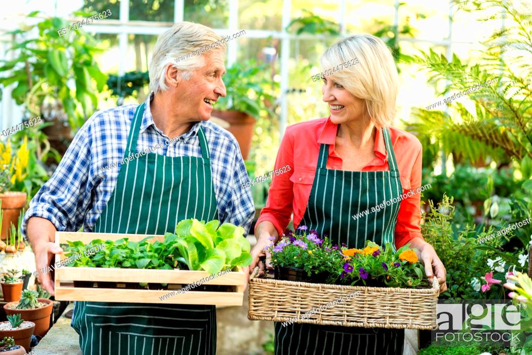 Stock Photo: Couple holding plant crates at greenhouse.