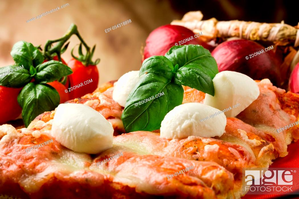 Stock Photo: delicious slice of pizza with buffalo mozzarella on wooden table.