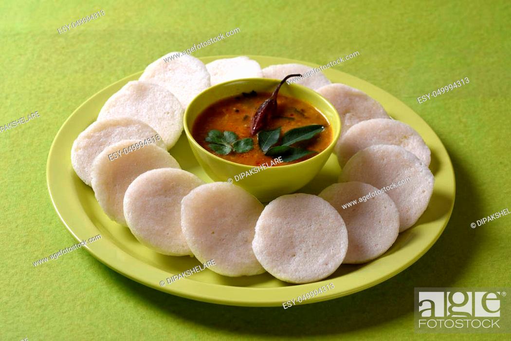 Stock Photo: Idli with Sambar in bowl on green background, Indian Dish: south Indian favourite food rava idli or semolina idly or rava idly.