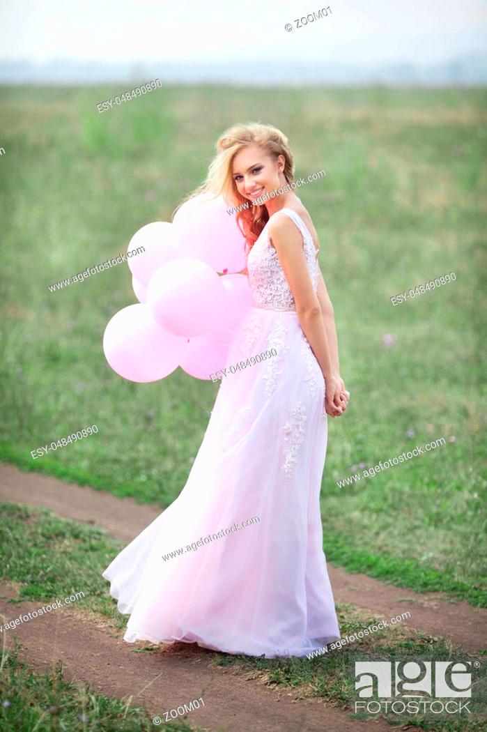 Blonde woman in lace dress holding pink heart balloon - stock photo 2974299  | Crushpixel