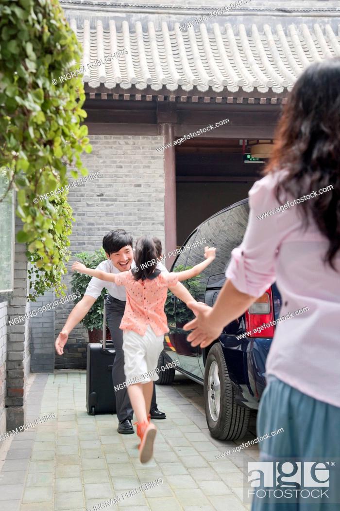 Stock Photo: Daughter Running to Hug Her Father.