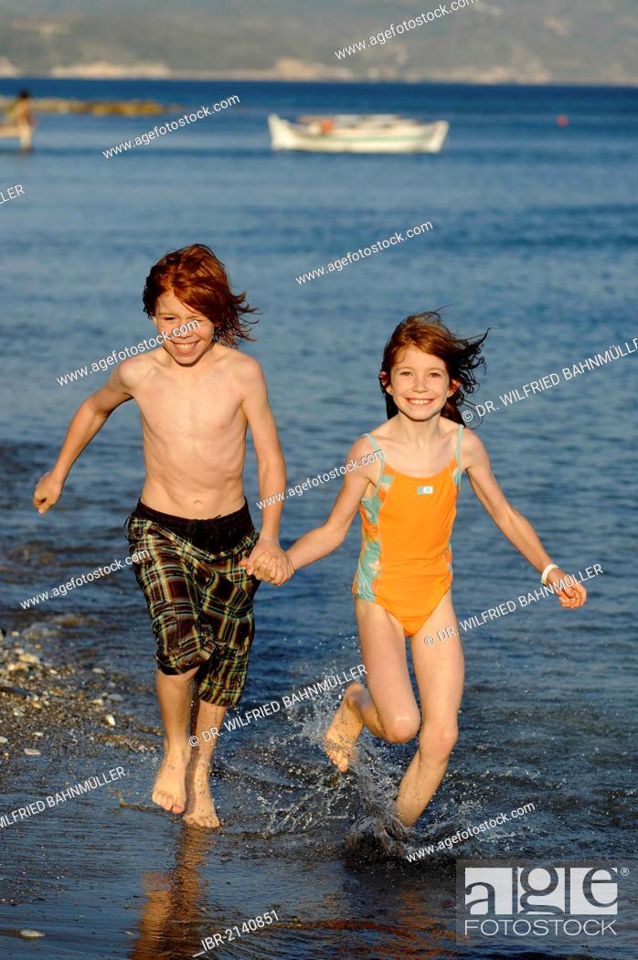 Stock Photo: Siblings running on the beach, happy, Samos island, southern Sporades, Aegean sea, Greece, Europe.