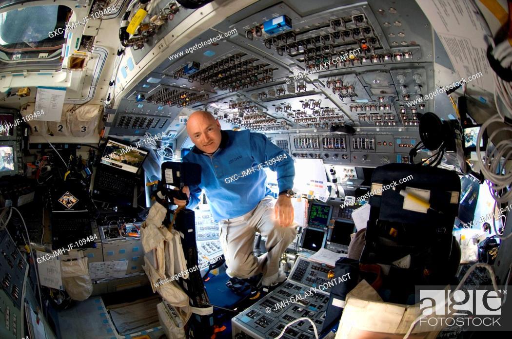 Astronaut Mark Kelly, STS-124 commander, takes a moment for a photo near the commander's station ...