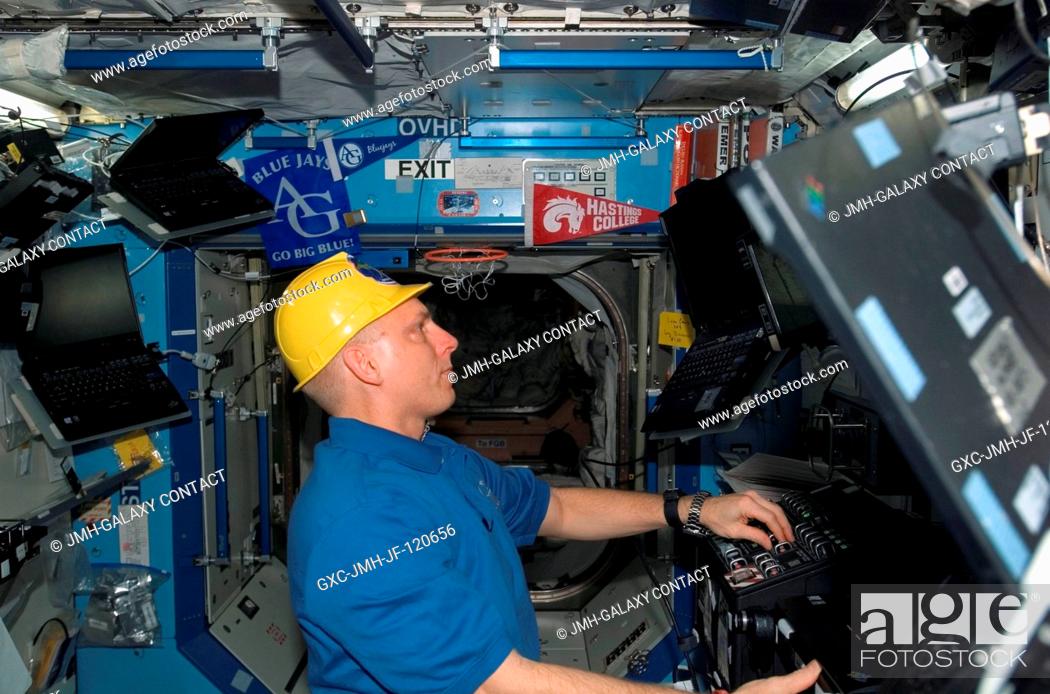 Stock Photo: Astronaut Clay Anderson, Expedition 15 flight engineer, works the controls of the station's robotic arm, Canadarm2, in the Destiny laboratory of the.