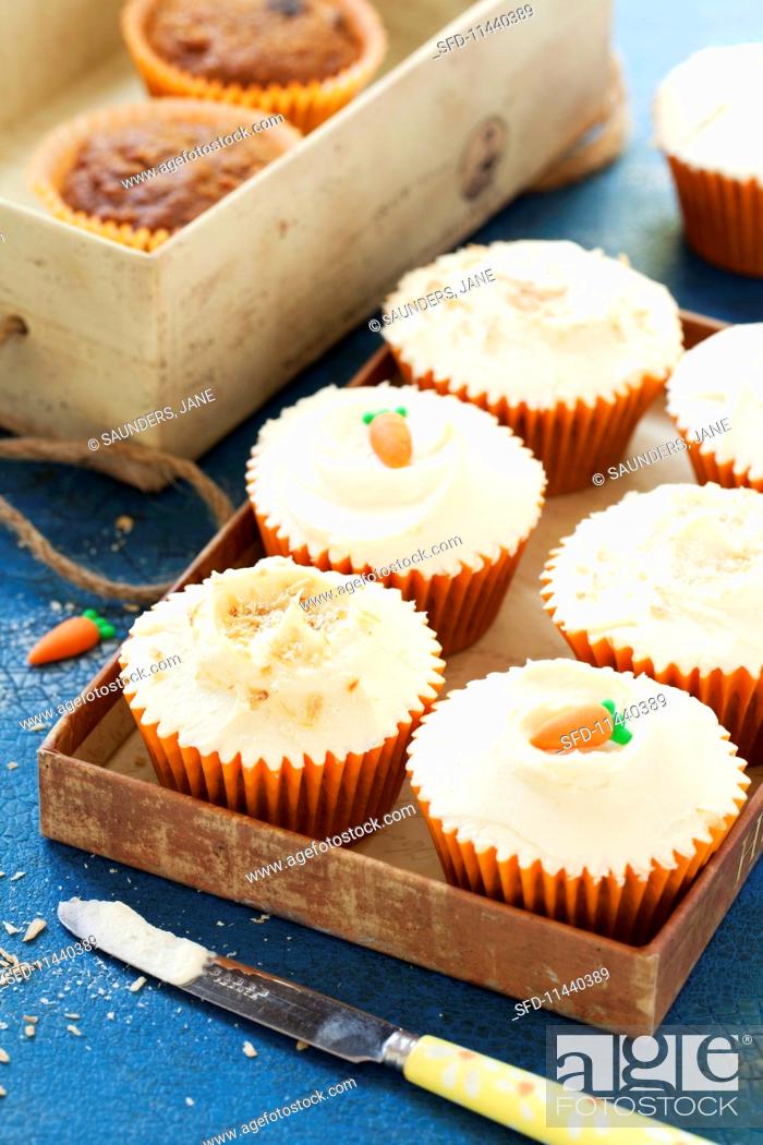 Stock Photo: Spelt and carrot cupcakes decorated with sugar carrots.