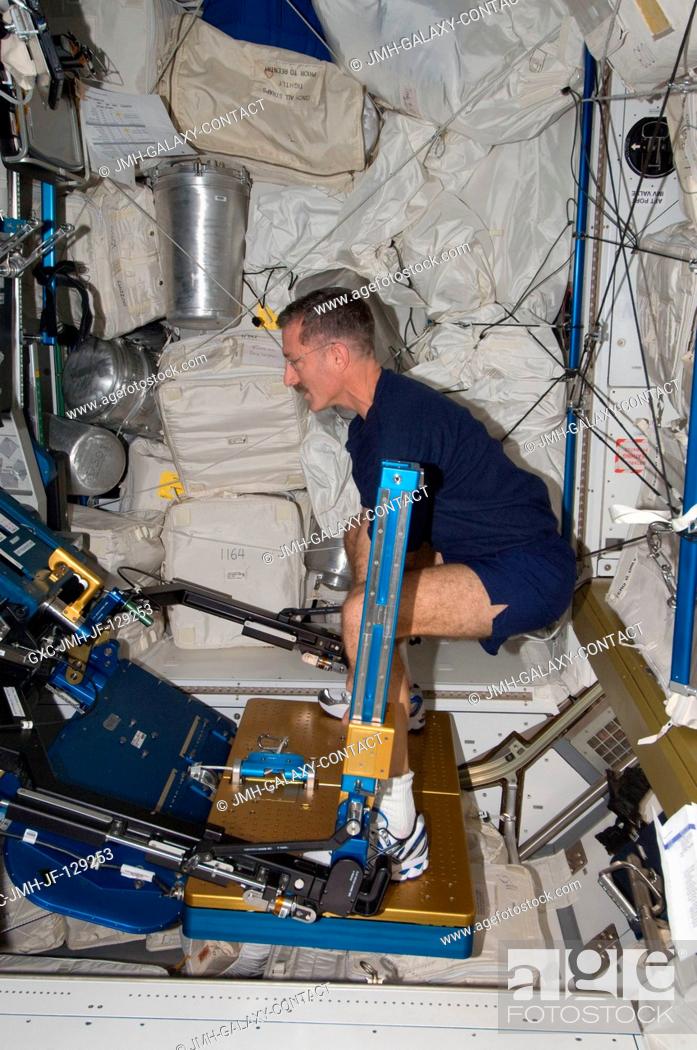 Stock Photo: NASA astronaut Dan Burbank, Expedition 30 commander, exercises using the advanced Resistive Exercise Device (aRED) in the Tranquility node of the International.