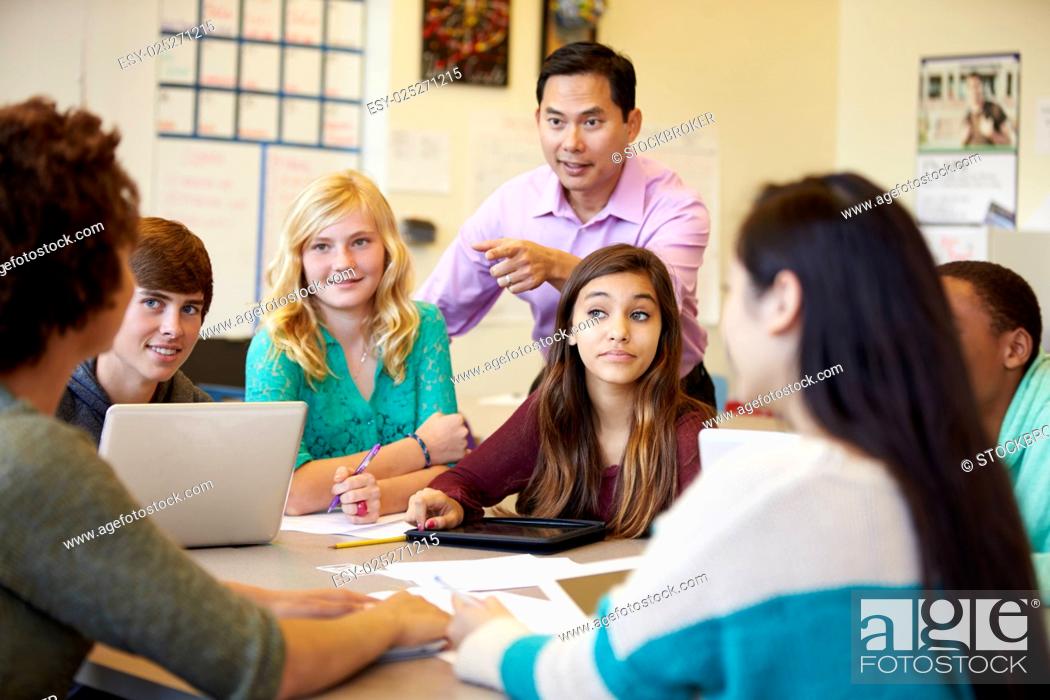 Stock Photo: High School Students With Teacher In Class Using Laptops.