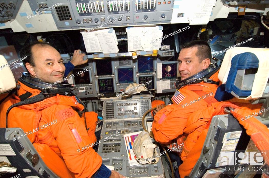 Stock Photo: Attired in their training versions of the shuttle launch and entry suit, astronauts Mark L. Polansky (left), STS-116 commander, and William A.