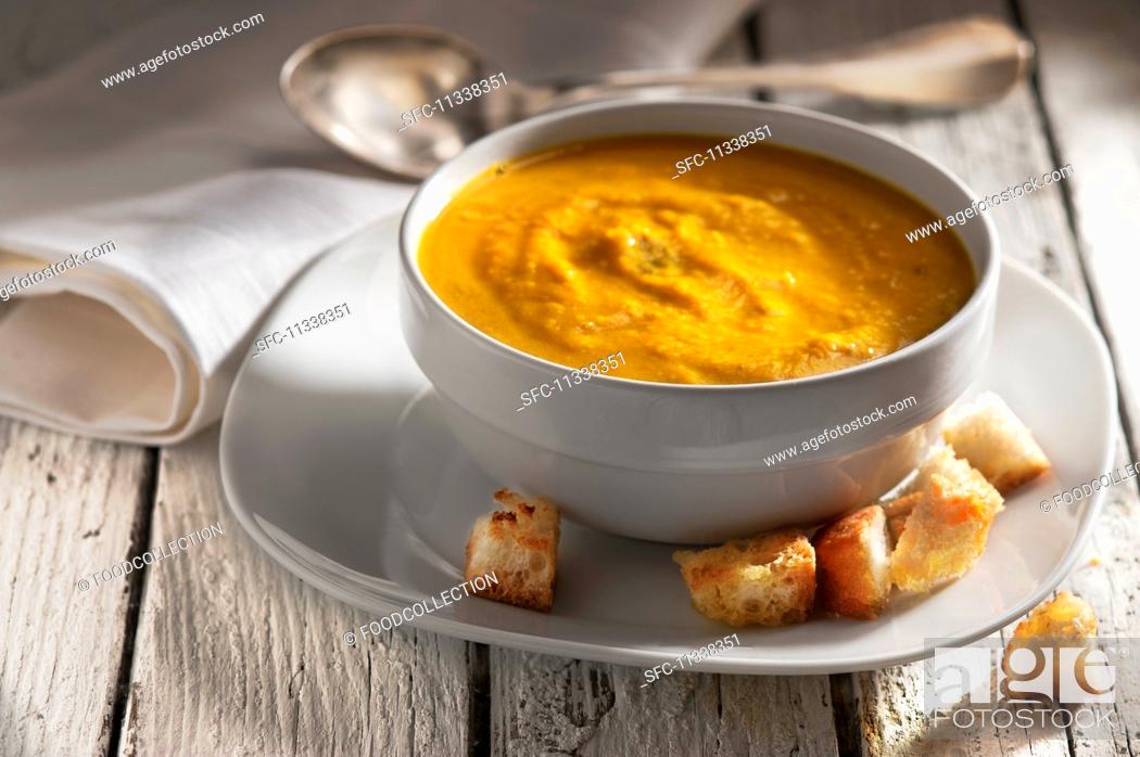 Stock Photo: Indian pumpkins and carrot soup with croutons.