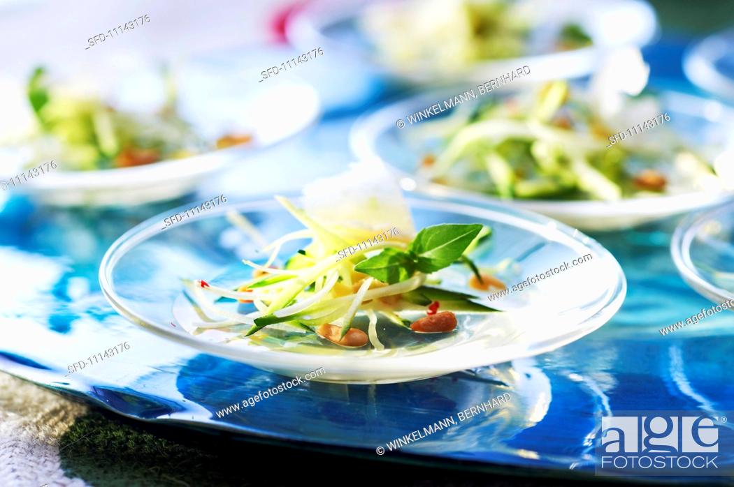 Stock Photo: Courgette salad with white wine jelly and pine nuts.