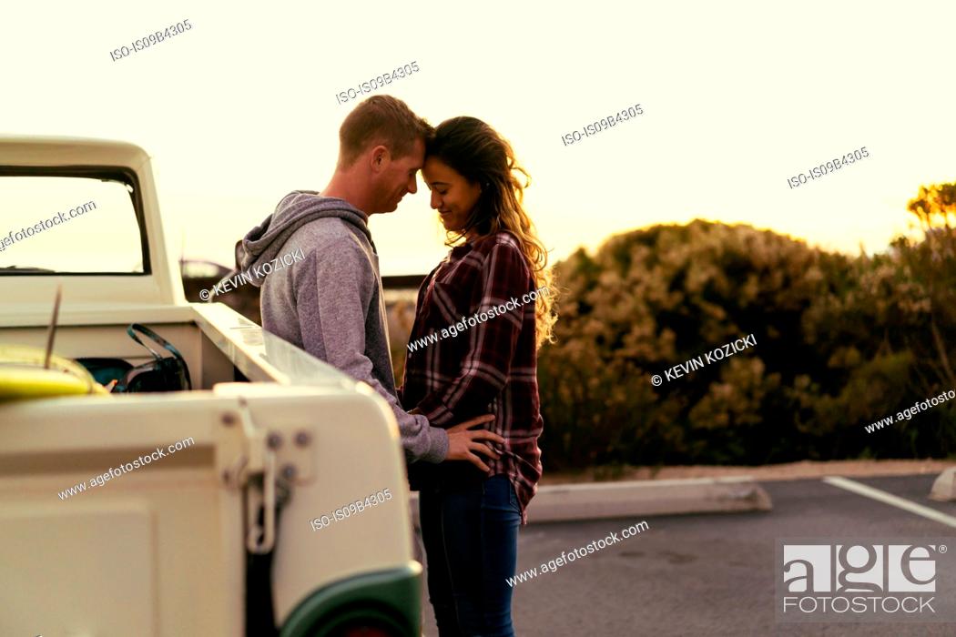 Stock Photo: Romantic couple with pickup truck at Newport Beach, California, USA.