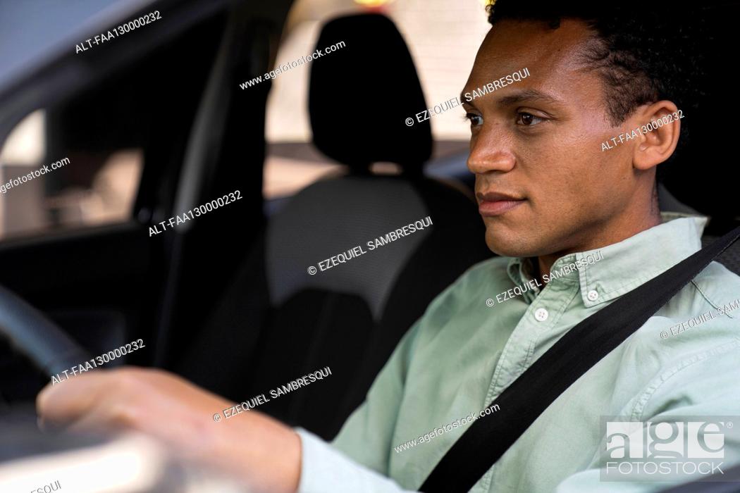 Photo de stock: Mid-shot portrait taken from outside the vehicle of African-American businessman driving his car to work.