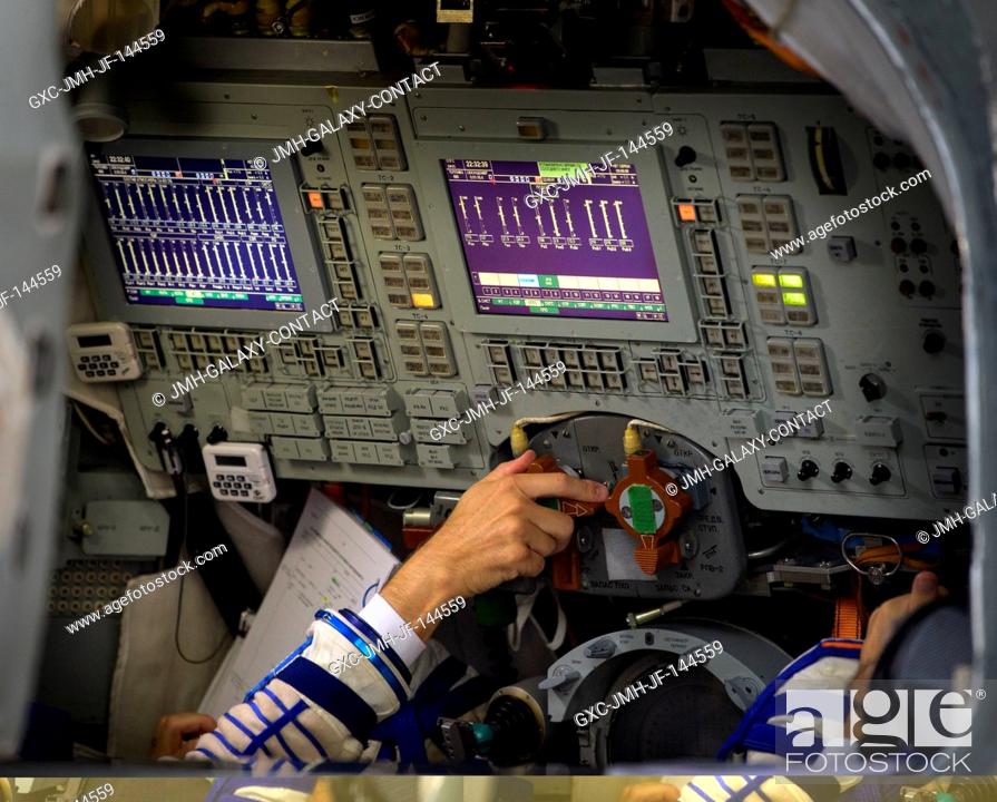 Stock Photo: Expedition 52 flight engineer Randy Bresnik of NASA turns a dial inside the Soyuz simulator during his final Soyuz qualification exam with fellow Expedition 52.