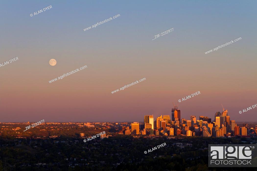 Stock Photo: Full Moon rising over Calgary skyline as shot from the CFCN Coach Hill location overlooking the city to the east. Moon came up about 6:55 pm and sunset was.