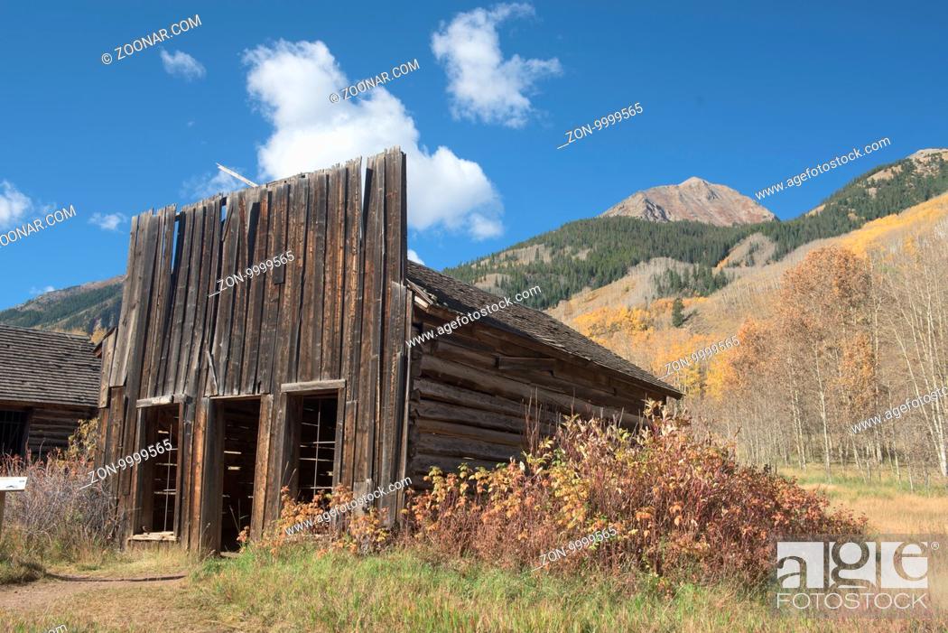 Stock Photo: An old abandoned store front in in the abandoned mining town of Ashcroft, in Colorado sits in the shadow of a large mountain.