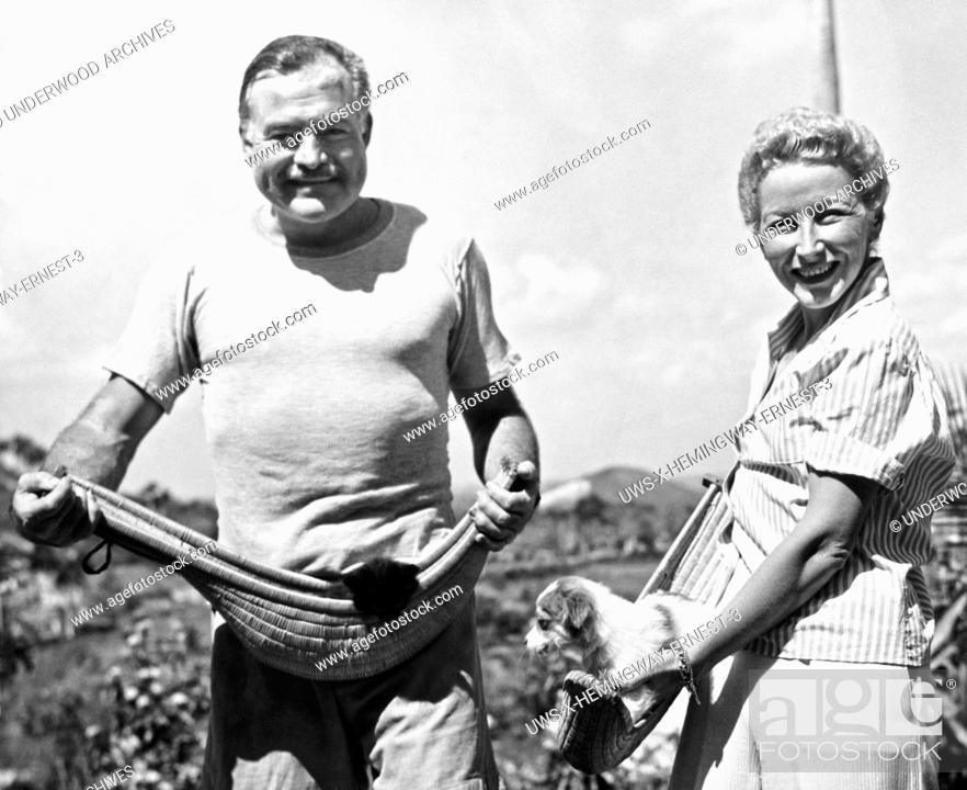 Stock Photo: Havana, Cuba: March 20, 1946.Author Ernest Hemingway and his fourth wife, Mary Welsh, hold their pets in jai alai baskets on the Hemingway farm in San Francisco.