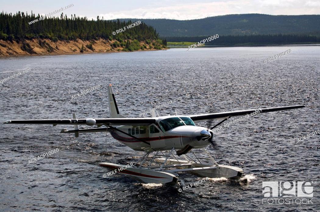 Stock Photo: Cessna Caravan amphibian airplane landing on Eagle River at Rifflin'Hitch Lodge in Southern Labrador, Newfoundland & Labrador, Canada.