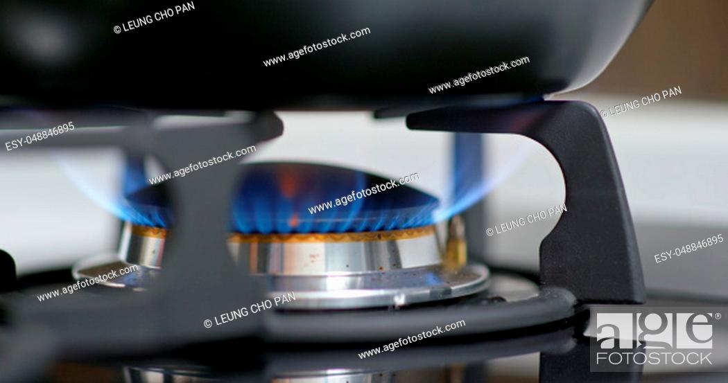 Stock Photo: Stove top burner igniting into a blue for cooking.