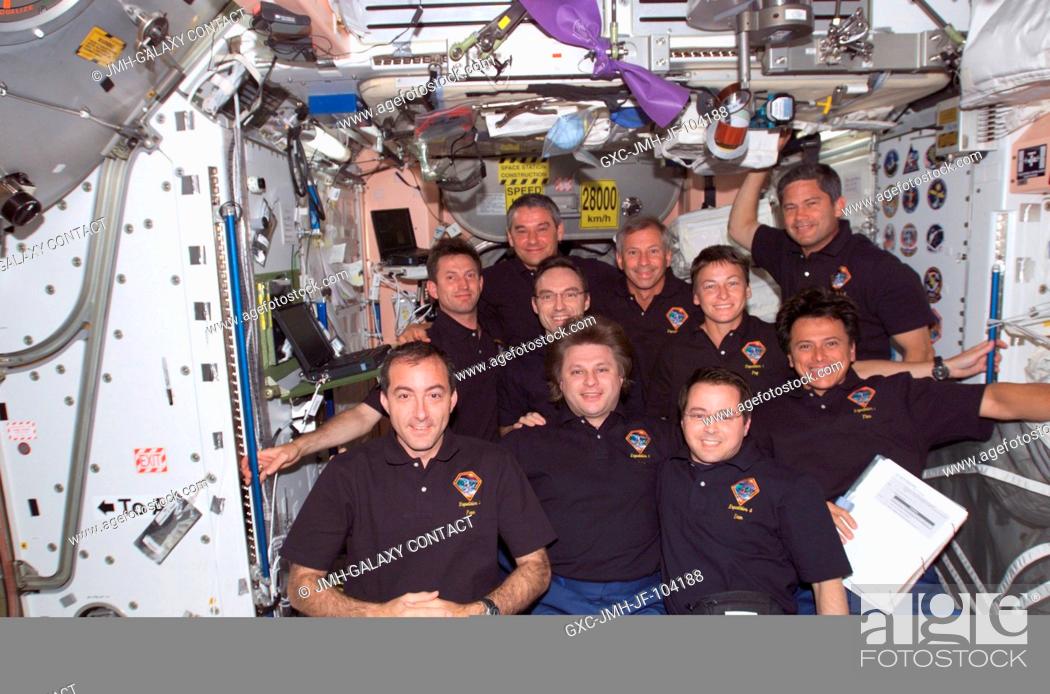 Stock Photo: The Expedition Four, STS-111, and Expedition Five crews assemble for a group photo in the Unity node on the International Space Station (ISS).