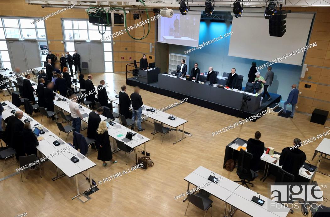 Stock Photo: 29 June 2022, Thuringia, Erfurt: The trial participants stand in the hearing room of the Congress Center of the Fairgrounds during a trial for drug trafficking.