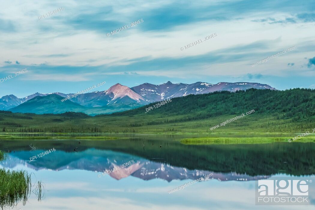 Stock Photo: Evening clouds breaking over Healy Lake in the Alaska Range in South-central Alaska on a cloudy summer evening; Alaska, United States of America.