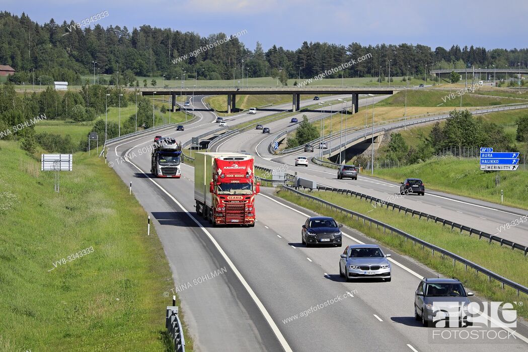 Stock Photo: Salo, Finland. June 15, 2019. Freeway traffic of freight trucks and cars on a sunny day of summer on European Route E18 in South of Finland.