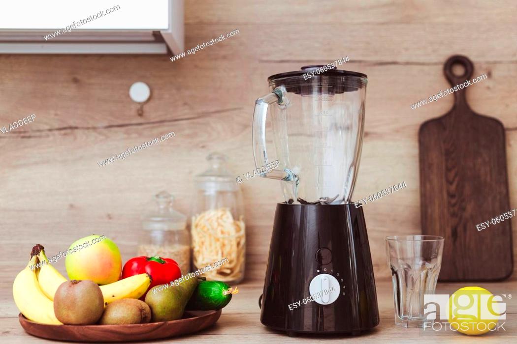 Stock Photo: Stationary blender and ingredients for healthy smoothie on table in kitchen.