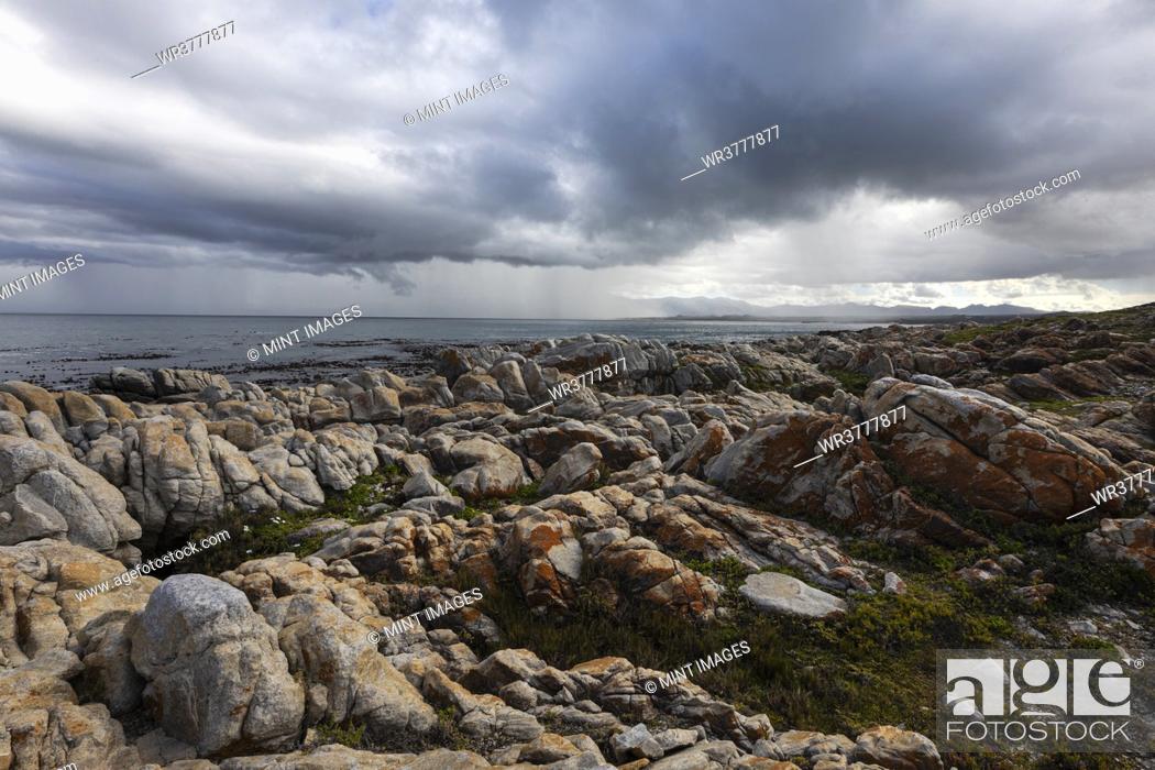 Stock Photo: Rocky jagged coastline, eroded sandstone rock, view out to the ocean.