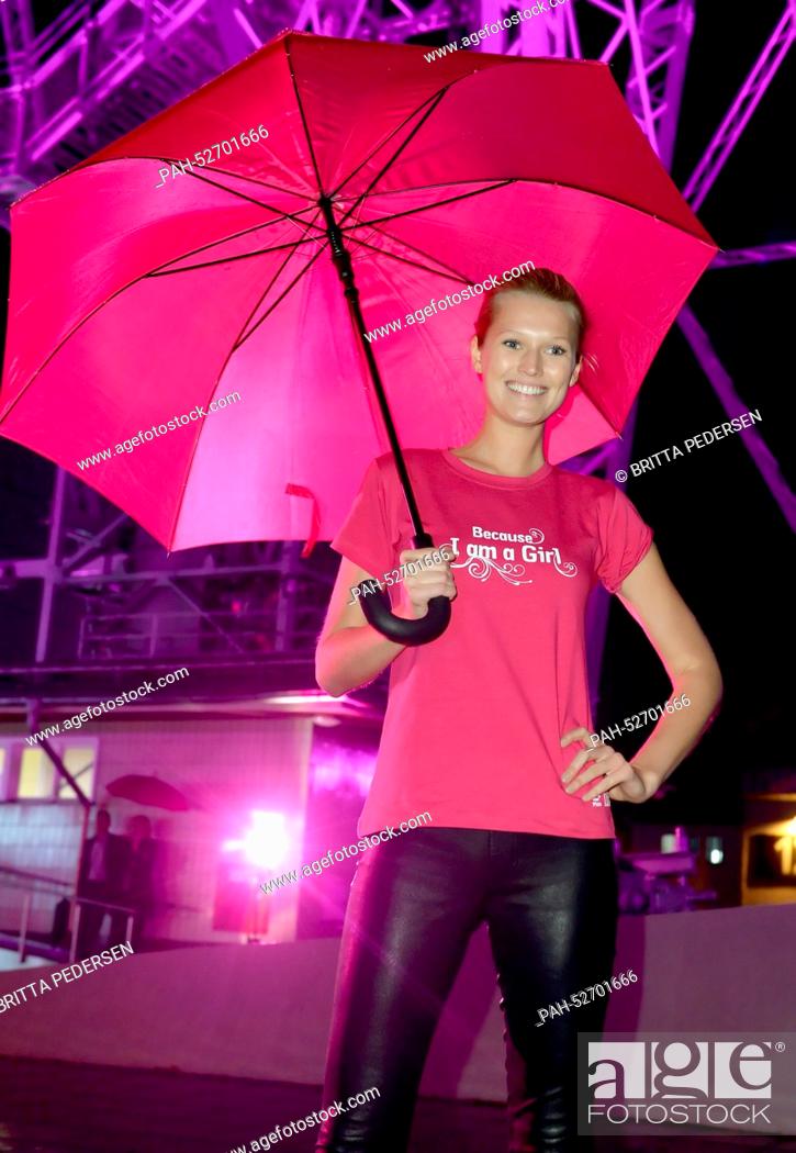 Stock Photo: Model Toni Garrn stands after turning on the pink lighting at the Radio Tower for the campagne ""Because I am a Girl"" for International Girls' Day on 11.