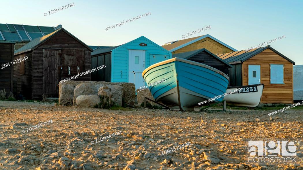 Stock Photo: Portland Bill, Jurassic Coast, Dorset, UK - April 22, 2017: The fisherman's huts with a fishing boat.