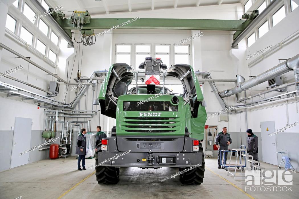 Stock Photo: Several employees do the quality check of a Fendt Katana 65 corn chopper in a former tank maintenance hall in Hohenmoelsen, Germany, 17 April 2015.