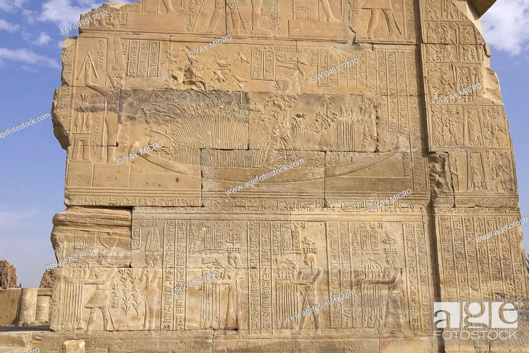 Stock Photo: Egyptian hieroglyphs and drawings on the walls and columns. Egyptian language, The life of ancient gods and people in hieroglyphics and drawings.