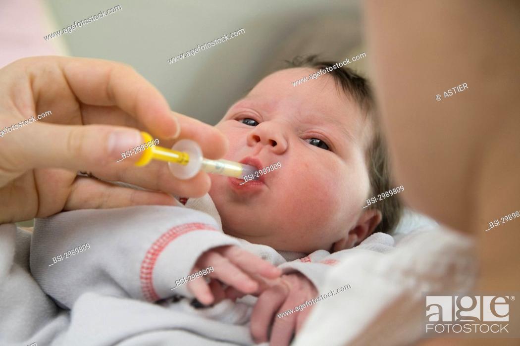 Stock Photo: Photo essay at the maternity of Saint-Vincent de Paul hospital, Lille, France. Administration of vitamin D to a newborn baby girl.