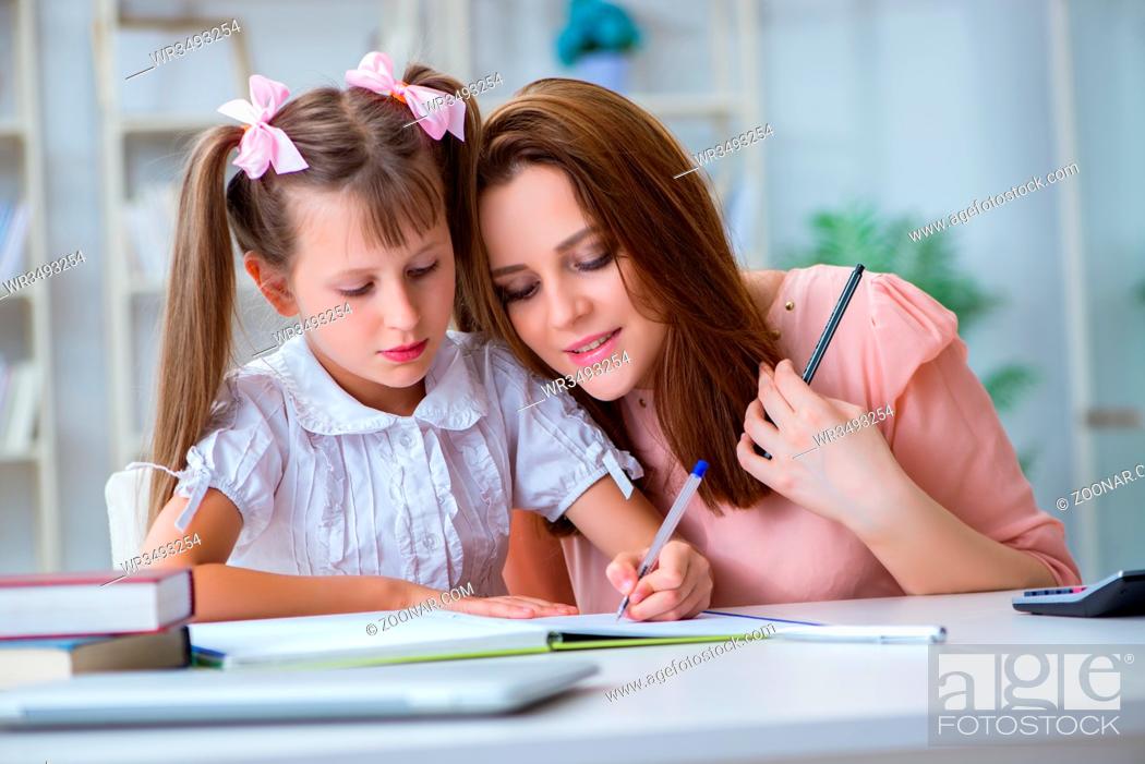 Stock Photo: Mother helping her daughter to do homework.