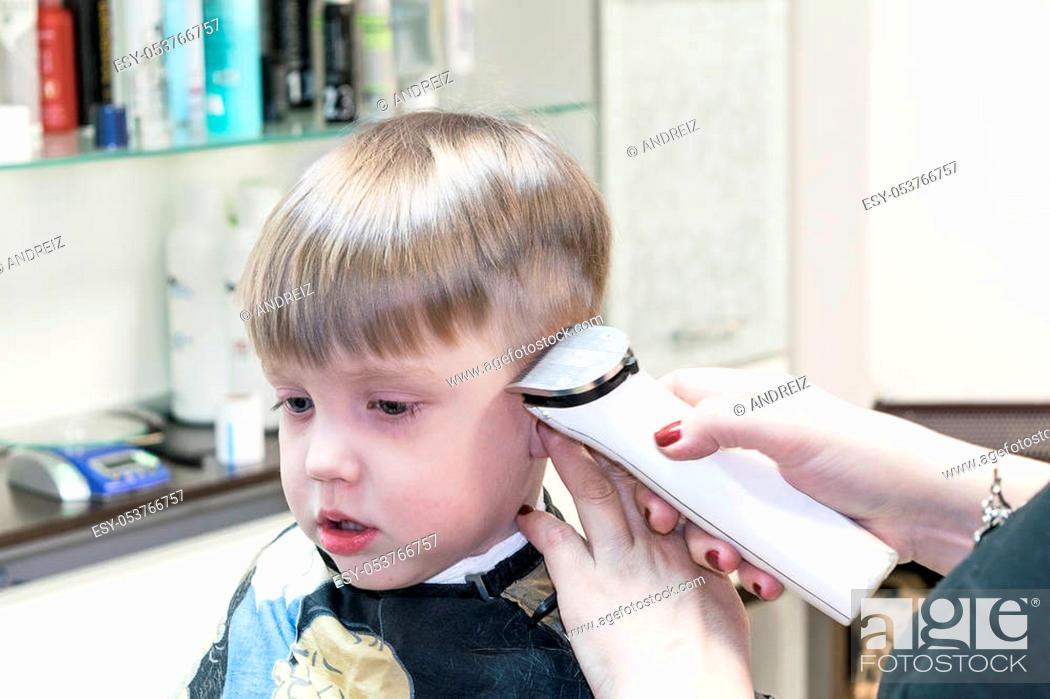 Little cute boy sitting in the chair at the hair salon. Covered with a  cloak, Stock Photo, Picture And Low Budget Royalty Free Image. Pic.  ESY-053766757 | agefotostock