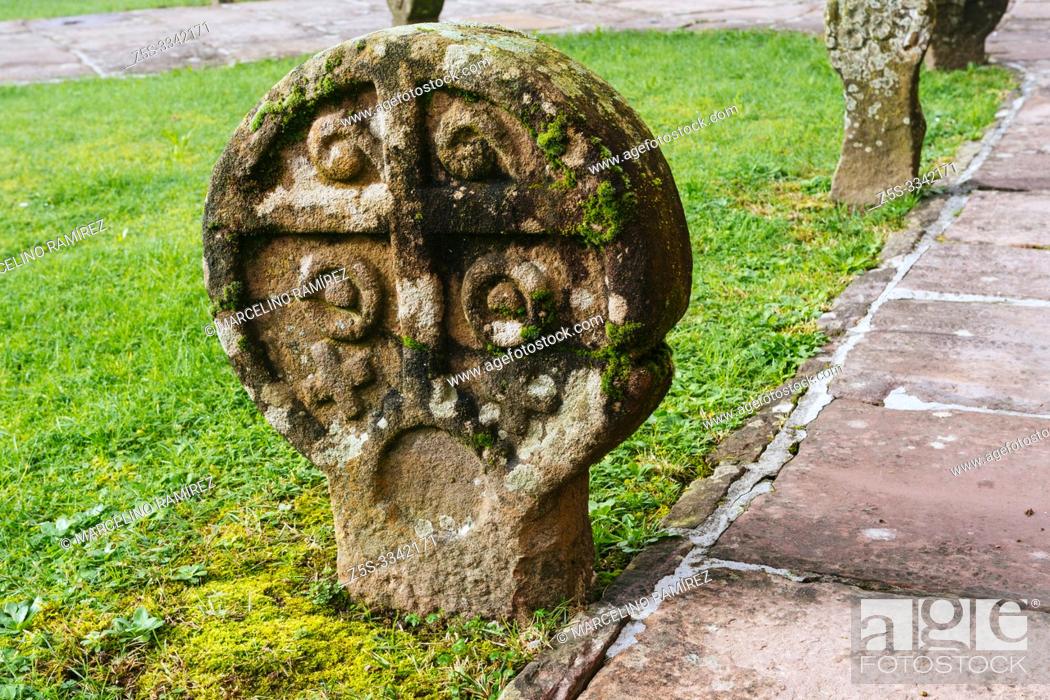 Stock Photo: Remains of an ancient cemetery with discoid steles. courtyard of Church of the Assumption, Etxalar, Cinco Villas, Bortziriak, Navarre, Spain, Europe.