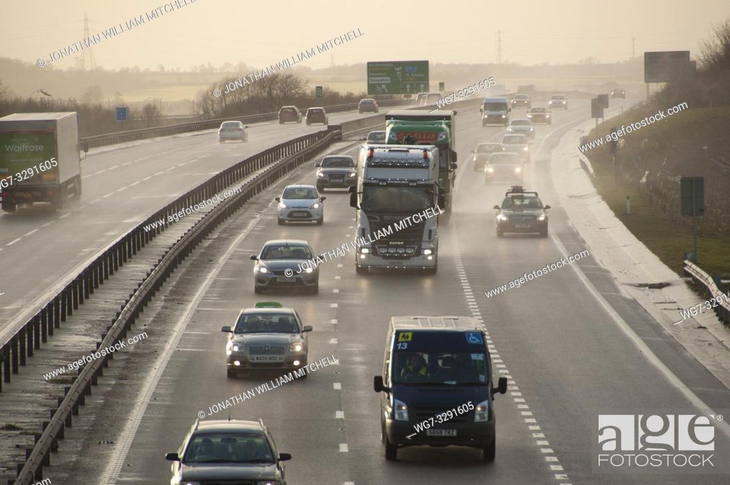 Stock Photo: BEDFORD, ENGLAND, UK - Feb 12, 2014: Cars and trucks on the A421 near Bedford, Bedfordshire, England, UK, during the storms of early 2014.