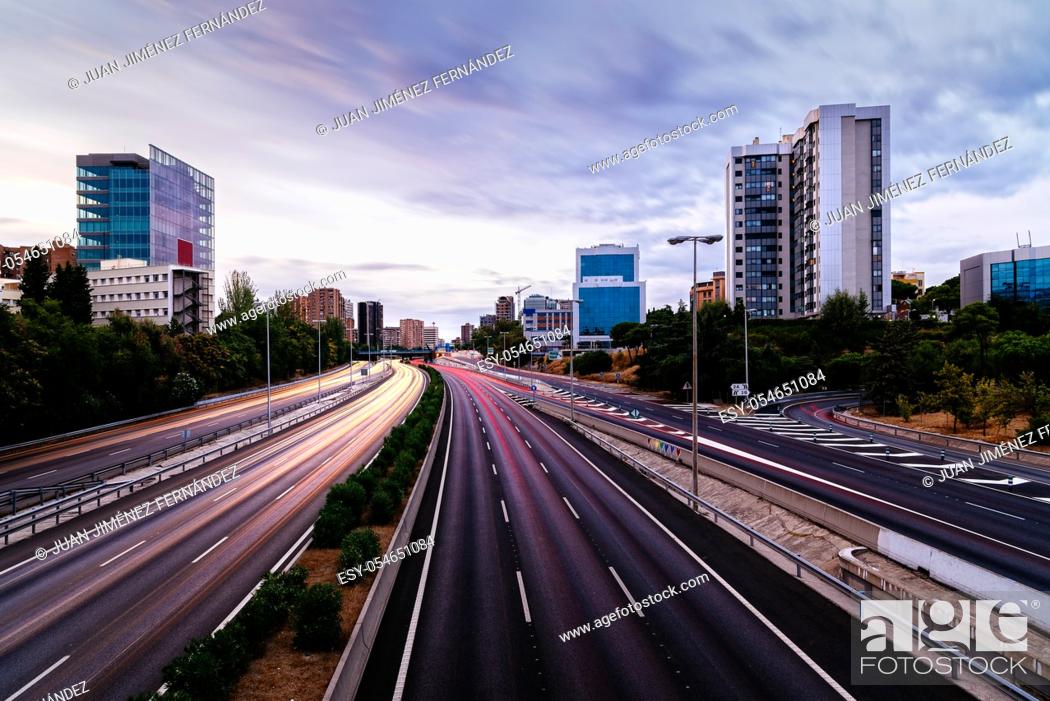 Stock Photo: M30 motorway in Madrid at sunset. Long exposure with traffic light trails.