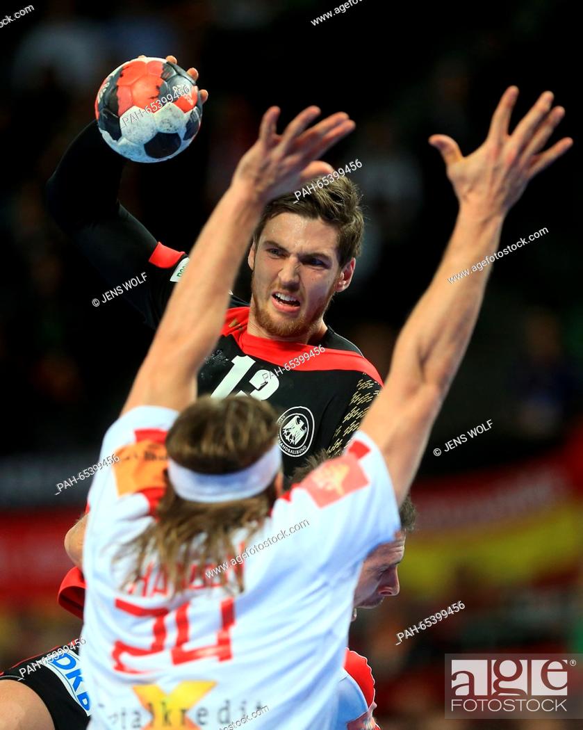 Stock Photo: Germany's Hendrik Pekeler in action against Denmark's Mikkel Hansen during the 2016 Men's European Championship handball group 2 match between Germany and.