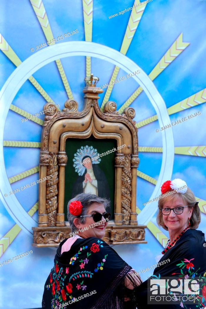Stock Photo: Madrid Spain; 08/15/2019. .Summer parties in Madrid, Spain. La Virgen de La Paloma a small painting that makes people dress up in Chulapos and Chulapas and goes.