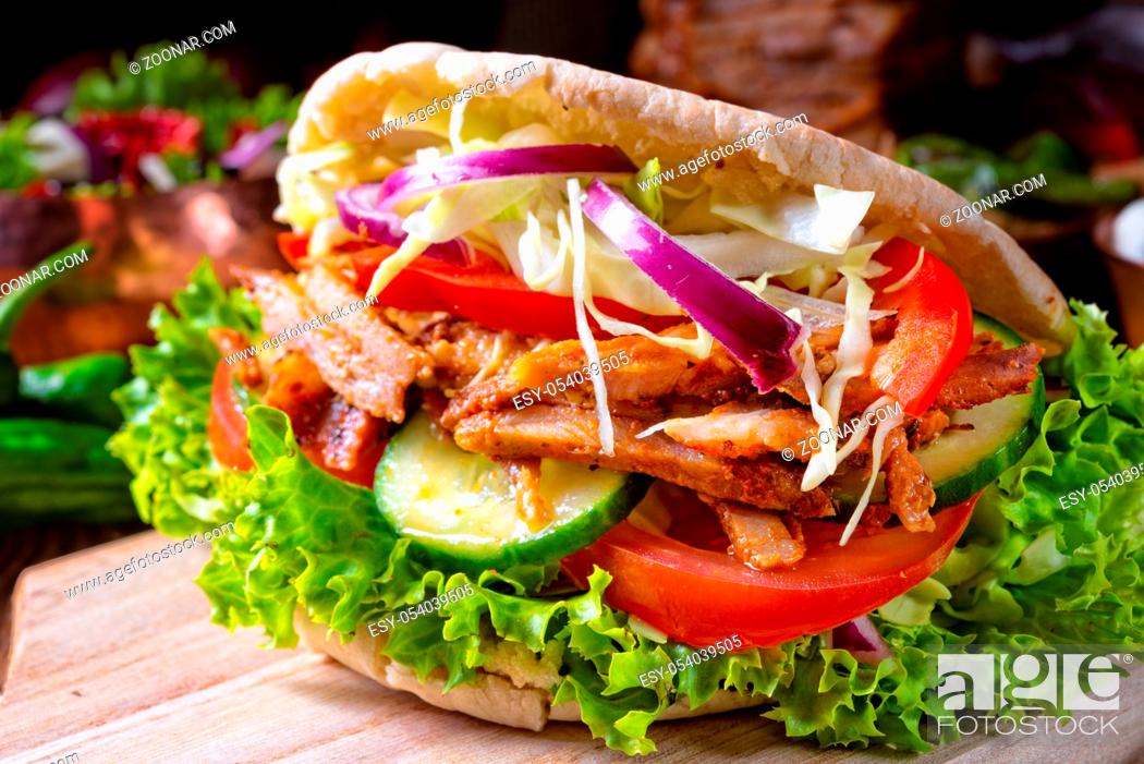 Stock Photo: Crunchy pita with grilled gyros meat. Various vegetables and garlic sauce.