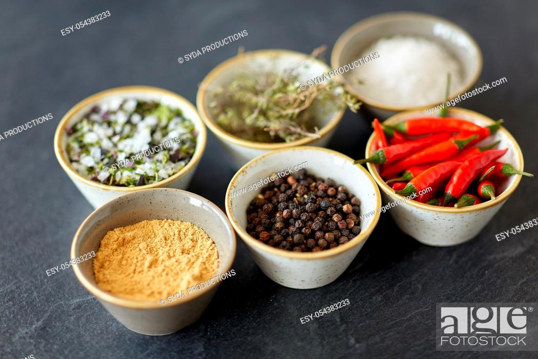 Stock Photo: bowls with different spices on slate stone table.
