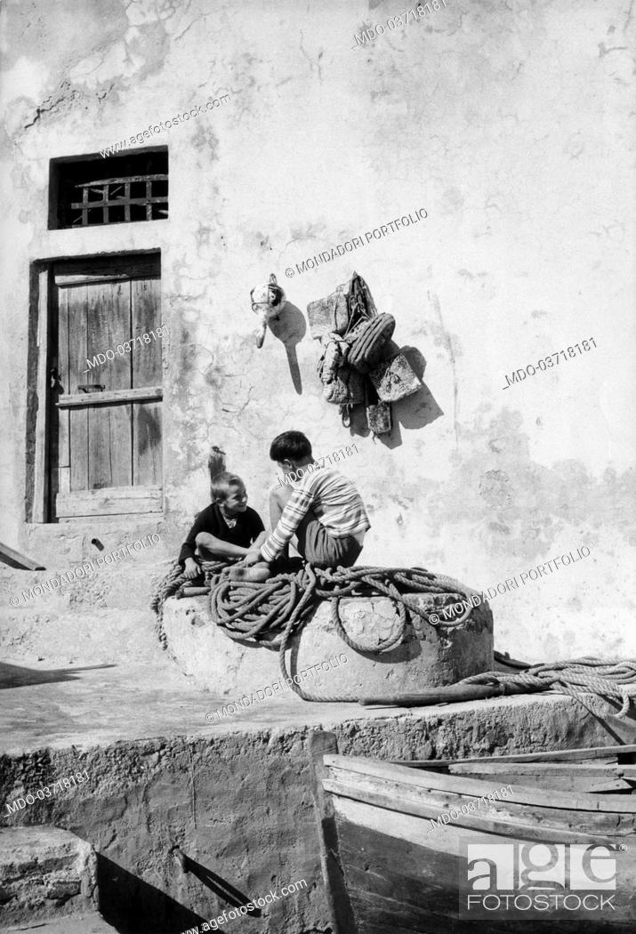 Stock Photo: Two children playing in front of a fisherman house. Gorgona, August 1960.