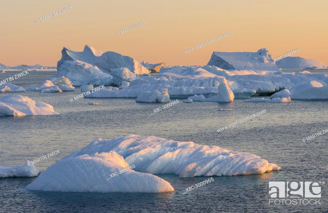 Stock Photo: Icebergs in the Disko Bay. The Inuit village Oqaatsut (once called Rodebay) located in the Disko Bay. America, North America, Greenland, Denmark.